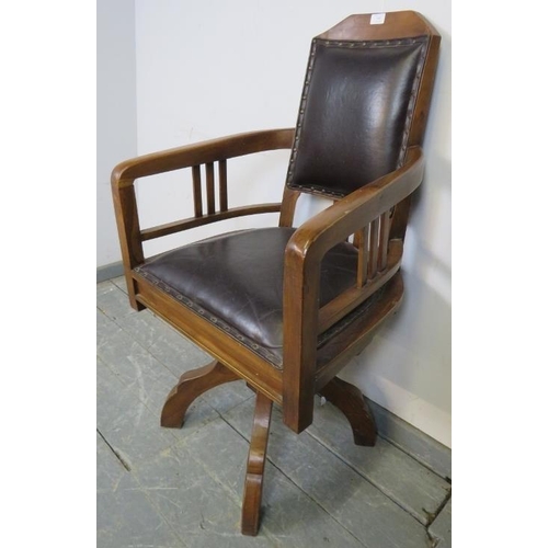 709 - An Edwardian walnut swivel height adjustable captain’s desk chair, upholstered in black leather with... 