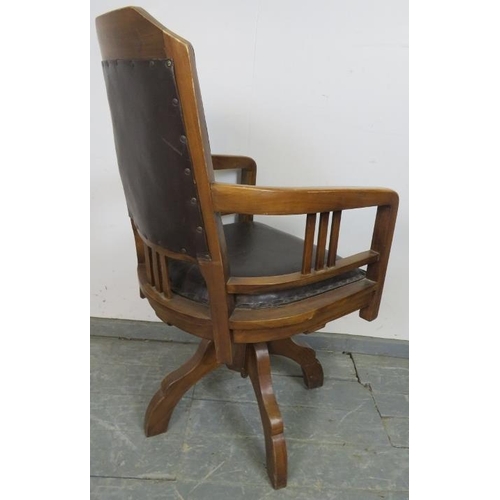 709 - An Edwardian walnut swivel height adjustable captain’s desk chair, upholstered in black leather with... 