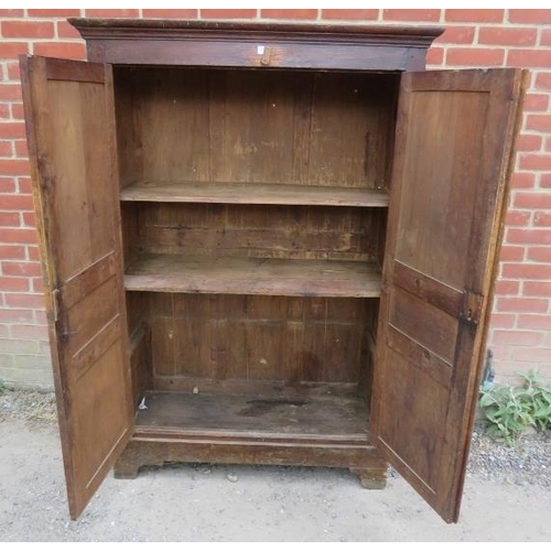 713 - An 18th century pine bacon/pantry cupboard, the panelled doors opening onto hanging rails above two ... 