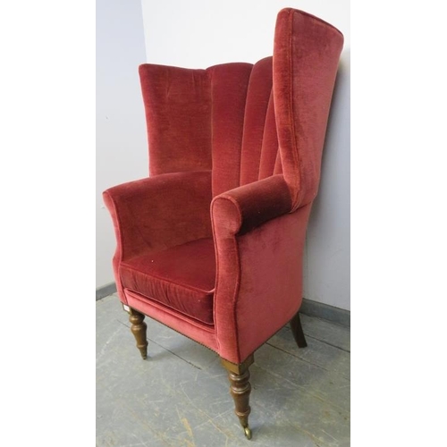 715 - An antique barrel back porter’s armchair in the Georgian style, upholstered in crimson velvet materi... 