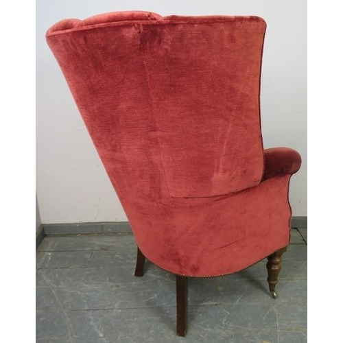 715 - An antique barrel back porter’s armchair in the Georgian style, upholstered in crimson velvet materi... 