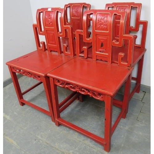 721 - Four early 20th century Chinese chairs in cinnabar red lacquer with gold accents, on square supports... 