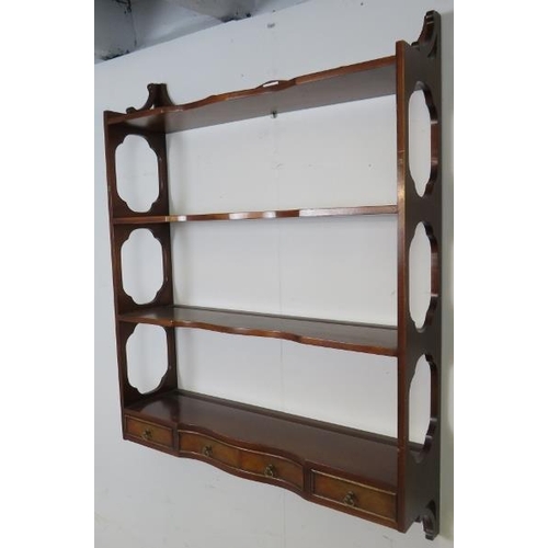 725 - A set of reproduction mahogany serpentine fronted wall-hanging shelves in the Georgian taste, with t... 