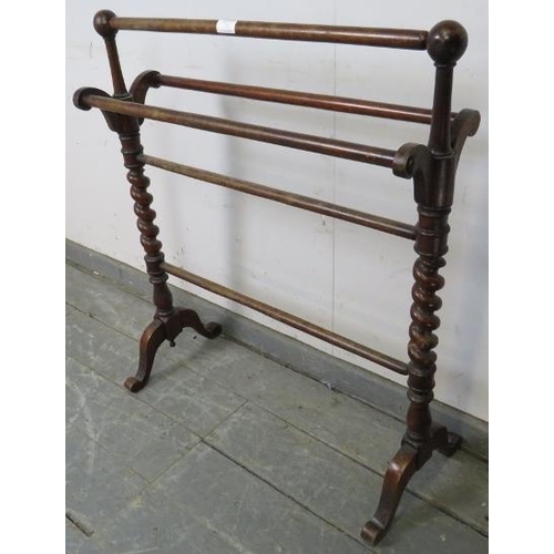 733 - A Victorian mahogany double towel rail, with barley twist uprights, on scrolled supports. 
H85cm W70... 