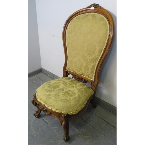 737 - A Victorian walnut spoonback nursing chair, upholstered in gold damask material, on scrolled support... 