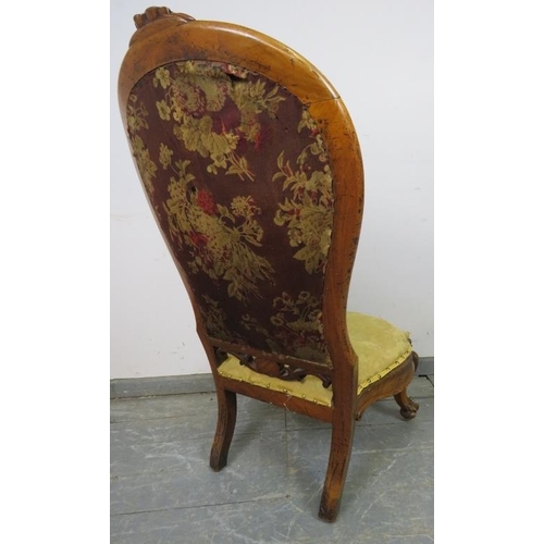 737 - A Victorian walnut spoonback nursing chair, upholstered in gold damask material, on scrolled support... 