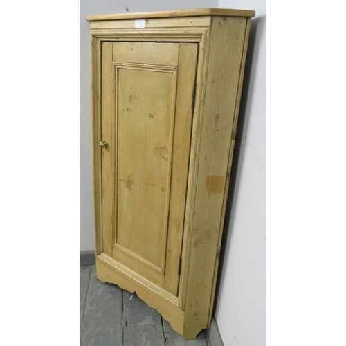 739 - An antique stripped pine floor standing corner cupboard, the panelled door opening onto one fitted s... 