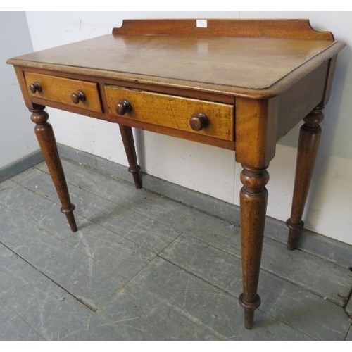 746 - A Victorian walnut writing table with rear gallery, housing two short drawers with turned wooden kno... 