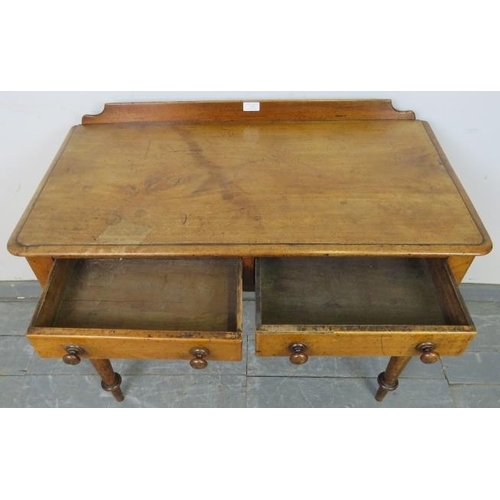 746 - A Victorian walnut writing table with rear gallery, housing two short drawers with turned wooden kno... 