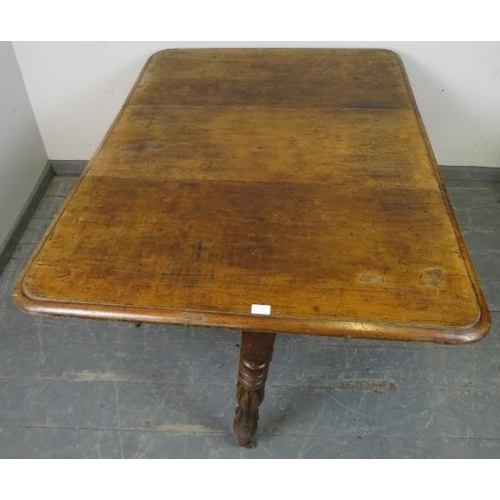 757 - A Victorian walnut drop-leaf table, on tapering turned and fluted supports with brass caps and casto... 