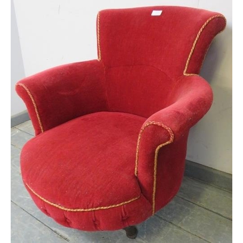 824 - A Victorian low armchair upholstered in crimson material with gold braid trim, on tapering reeded su... 