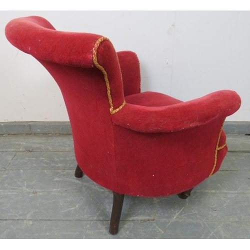 824 - A Victorian low armchair upholstered in crimson material with gold braid trim, on tapering reeded su... 