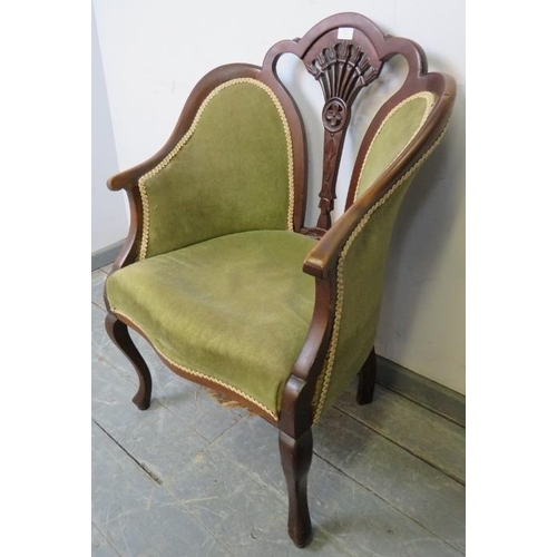 830 - An Edwardian mahogany show-wood armchair with carved and pierced back, upholstered in green velvet m... 