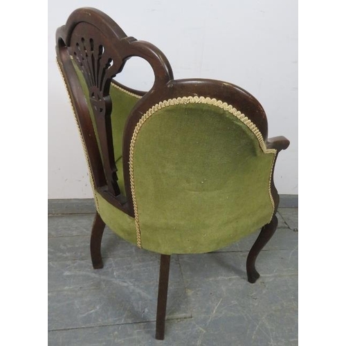 830 - An Edwardian mahogany show-wood armchair with carved and pierced back, upholstered in green velvet m... 