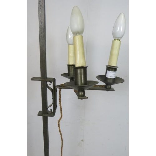 831 - A vintage wrought iron height adjustable standard lamp in the Gothic taste, with top finial and thre... 