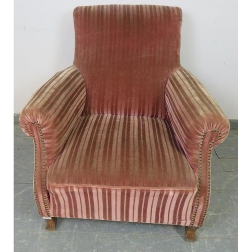 866 - An antique French club armchair upholstered in brown striped velveteen material with brass studs, on... 