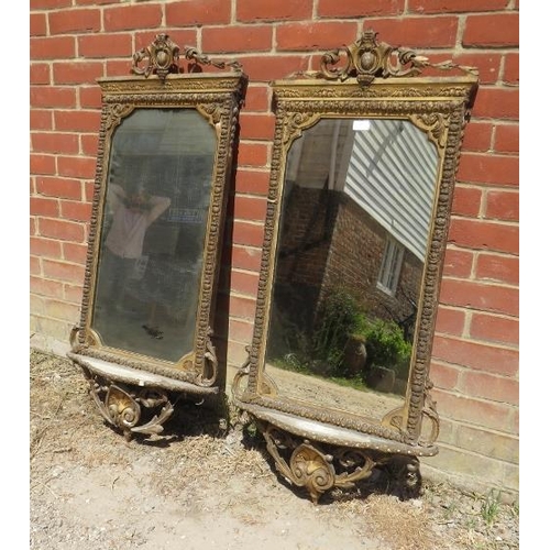 869 - A pair of 19th century Italian gilt gesso wall mirrors in ornate surrounds depicting scrolling acant... 