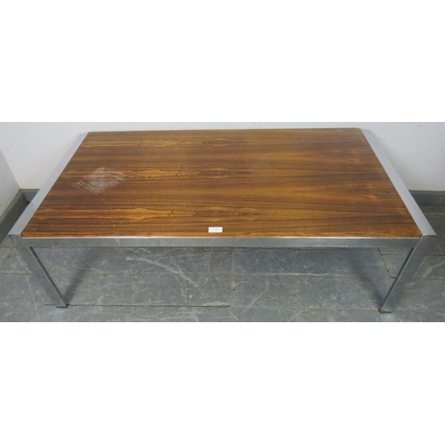 876 - A mid-century rosewood and chrome coffee table in the manner of Merrow Associates, on chrome support... 