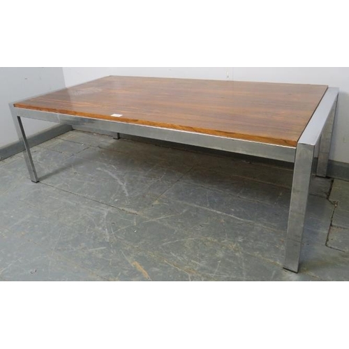 876 - A mid-century rosewood and chrome coffee table in the manner of Merrow Associates, on chrome support... 