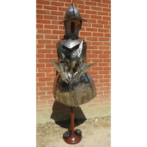 879 - A life-size replica 15th century Spanish style suit of armour in steel and brass, on a turned hardwo... 