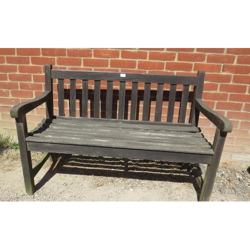 884 - A weathered teak slatted two-seater garden bench, on square supports with side stretchers. 
H84cm W1... 