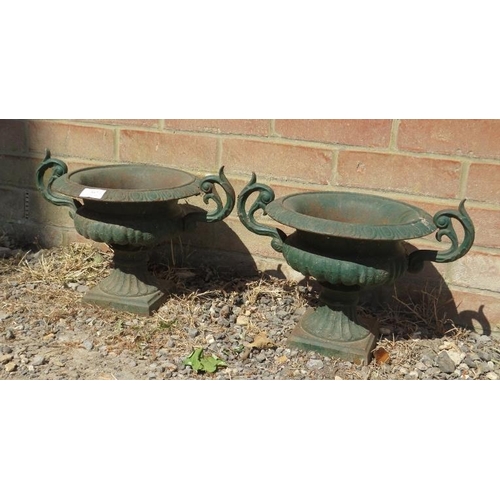 887 - A pair of cast iron twin handled   garden urns in the Neo-Classical taste, with fluted decoration, o... 