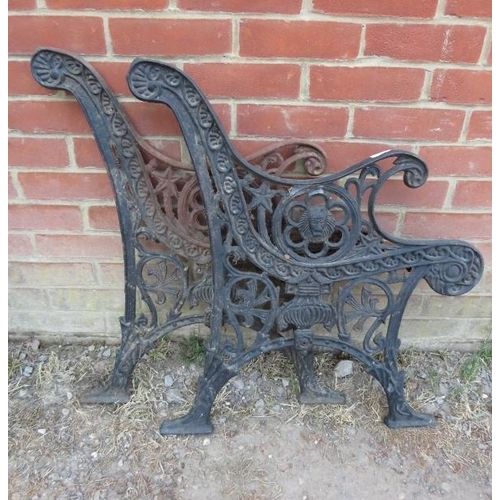 890 - A pair of cast iron bench ends, with pierced decoration featuring lion masks and classical urns. 
H7... 