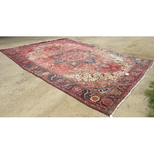 901 - A good quality mid 20th century Persian carpet central star burst motif, on pale red ground with dee... 