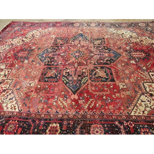 901 - A good quality mid 20th century Persian carpet central star burst motif, on pale red ground with dee... 