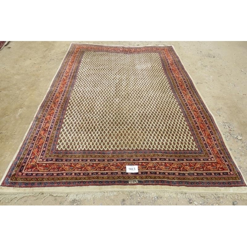 903 - A 20th century Persian rug with central block pattern on cream ground. Condition and colour good. 31... 