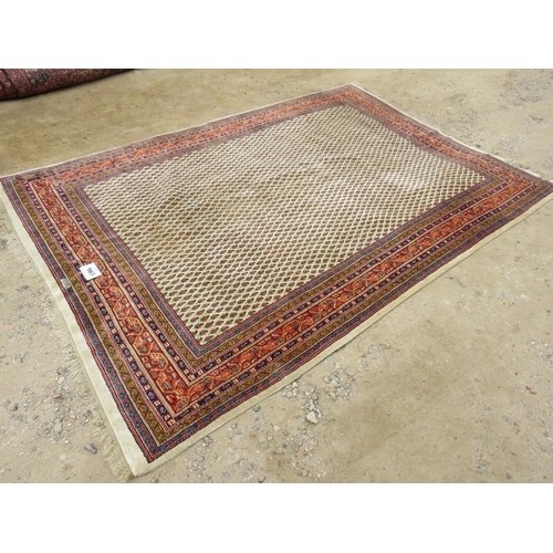 903 - A 20th century Persian rug with central block pattern on cream ground. Condition and colour good. 31... 