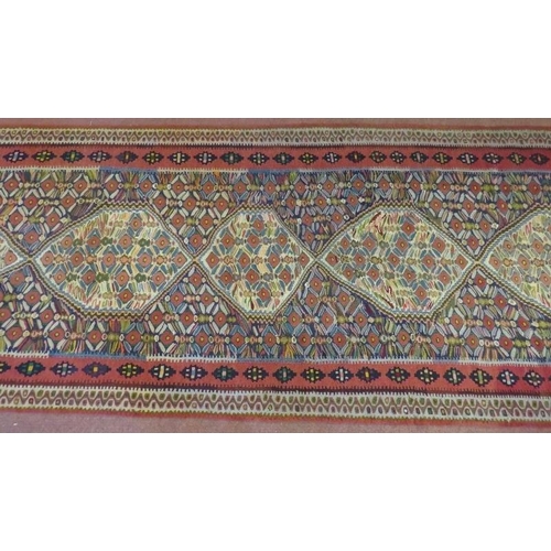 912 - A good North West Persian Senneh Kilim runner, 7 central panels on a patterned ground and in good co... 