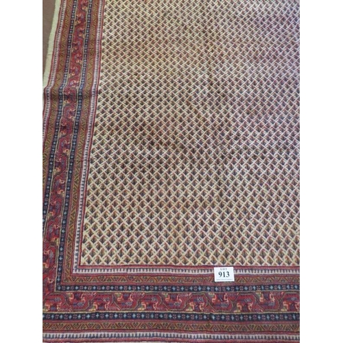 913 - A North East Persian Sarouk Mir carpet central repeat pattern field on cream ground and deep border.... 