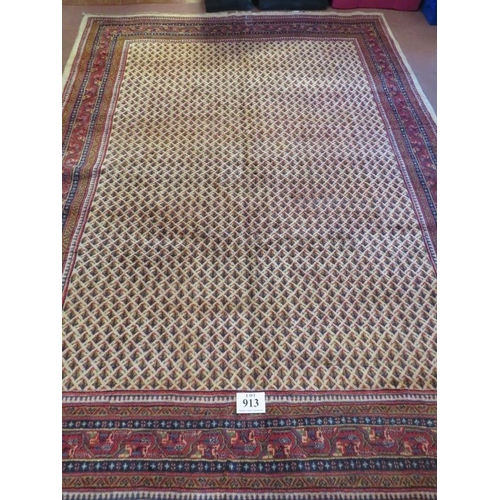 913 - A North East Persian Sarouk Mir carpet central repeat pattern field on cream ground and deep border.... 