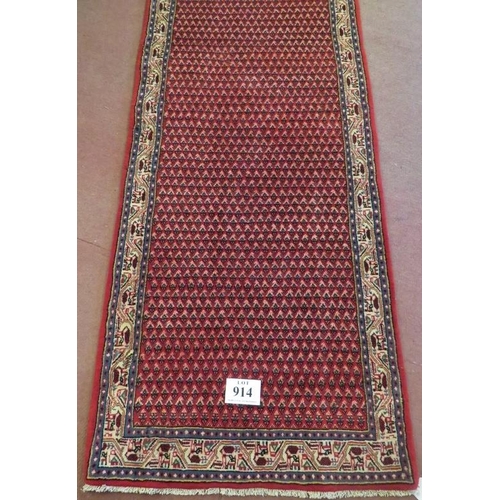 914 - North East Persian Mir runner central repeat pattern field on red ground and in good condition. 3.80... 