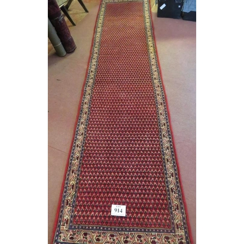 914 - North East Persian Mir runner central repeat pattern field on red ground and in good condition. 3.80... 