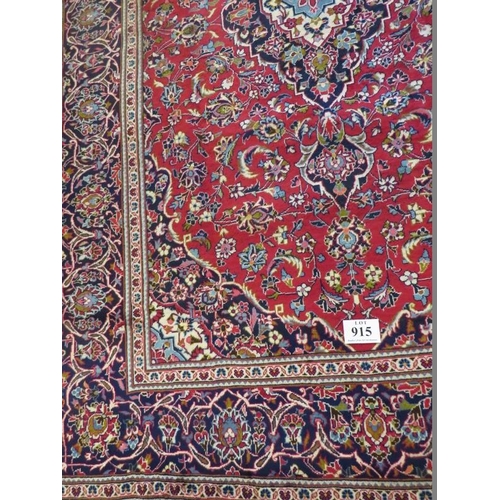 915 - Central Persian Kashan carpet central flowered motif cream/blue on red ground. Very clean and in goo... 