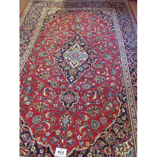 915 - Central Persian Kashan carpet central flowered motif cream/blue on red ground. Very clean and in goo... 