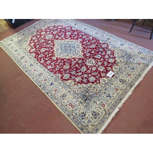 920 - A Persian meshed rug, central cream floral motif on a red ground and cream borders. 255 x 165.