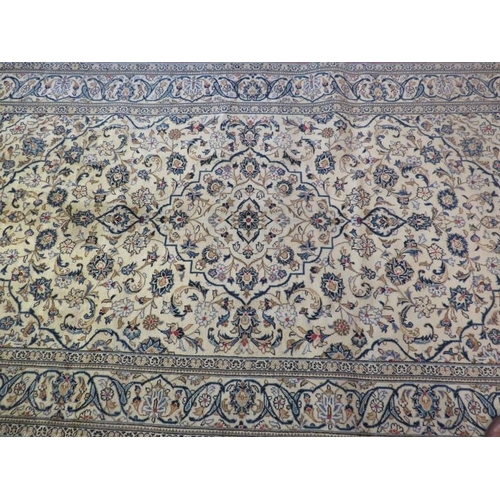 922 - A Persian Yazd carpet cream ground with heavy floral motifs and in good condition. 250 x 150.