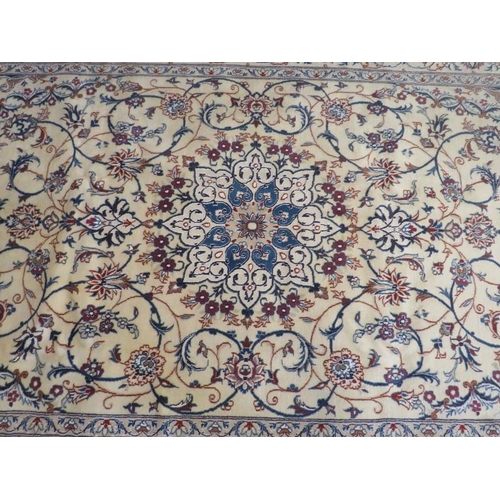 929 - A fine Persian Nain carpet, central motif on cream ground with foliage design. In good condition. 26... 