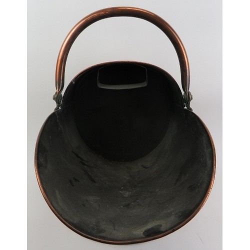 129 - A copper coal scuttle and shovel, late 19th/early 20th century. (2 items) Coal Scuttle: 18 in (46 cm... 