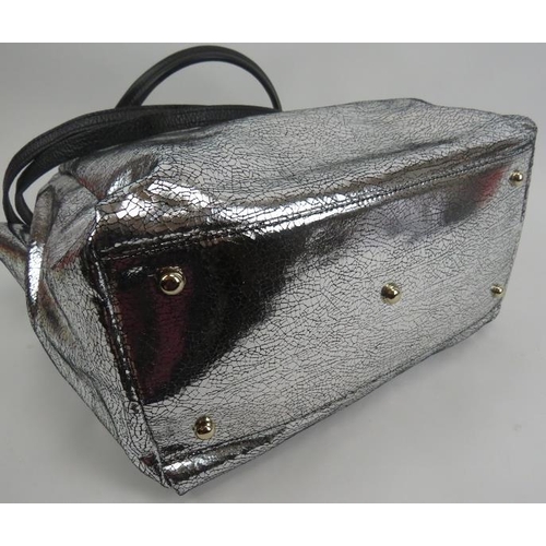 484 - A large Paul Costelloe handbag with silver crackle metallic decoration and added shoulder strap, wit... 