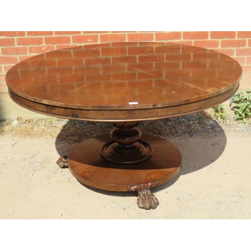 725 - An early Victorian mahogany circular tilt-top dining table, the top with sectioned veneer, on a bulb... 