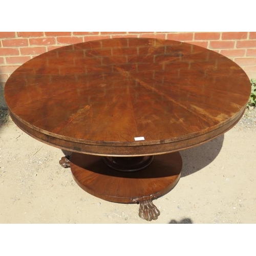 725 - An early Victorian mahogany circular tilt-top dining table, the top with sectioned veneer, on a bulb... 