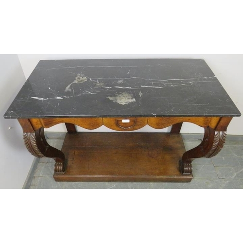 779 - A 19th century oak console table with black marble loose top, central shield decoration and curved s... 