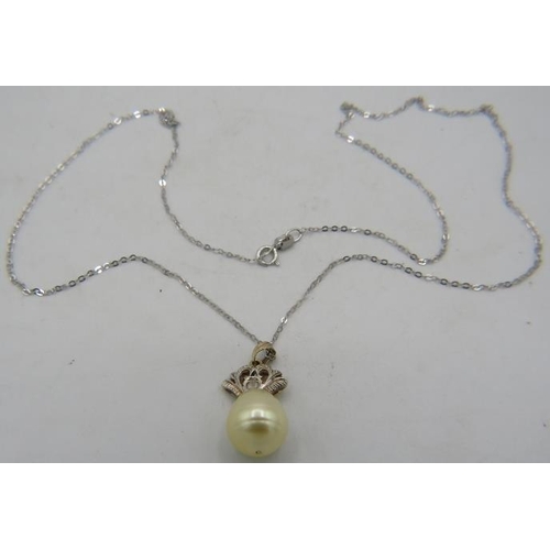 430 - A South Sea pearl & diamond pendant, pearl approx 10mm across. Indistinct marks on bail, on a fine 1... 