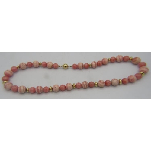 462 - A rhodocrosite necklace interspersed with yellow metal spacers and a 9ct yellow gold clasp, boxed. A... 