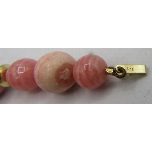 462 - A rhodocrosite necklace interspersed with yellow metal spacers and a 9ct yellow gold clasp, boxed. A... 