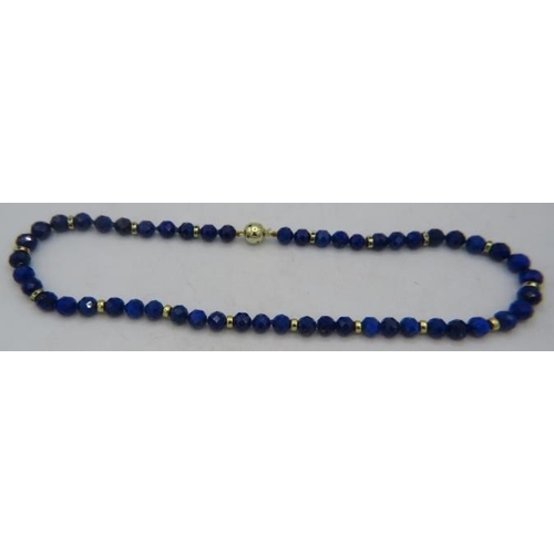 470 - A fine AAAA quality faceted cut lapis lazuli necklace with 14ct yellow gold ball clasp set with emer... 